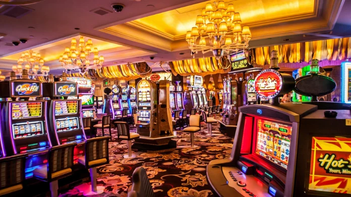 Färgglada spelautomater och blinkande lampor i ett casino med lyxiga mattor och taklampor.