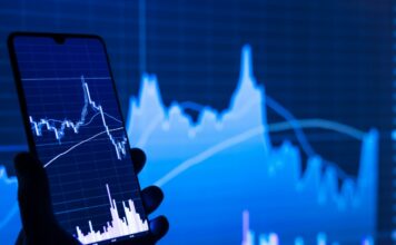stock charts showing on a mobile phone and screen