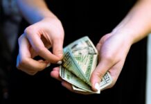 a person counting out cash