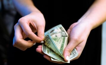 a person counting out cash