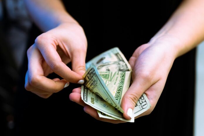 a person counting out cash
