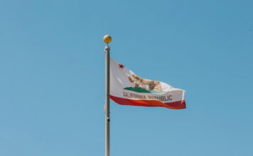 California flag flying in the wind on top of a building