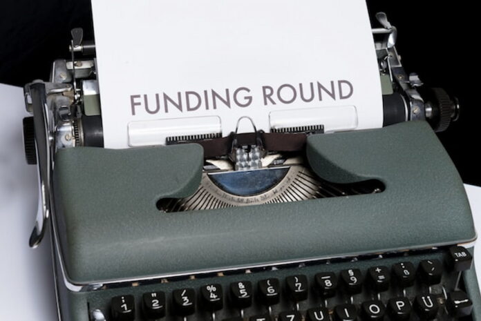Typewriter with a Funding Round Paper