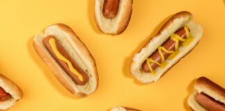 A series of hot dogs displayed on a yellow background