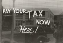 Window with pay your tax here written on it.