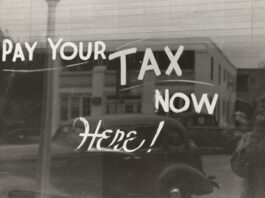 Window with pay your tax here written on it.