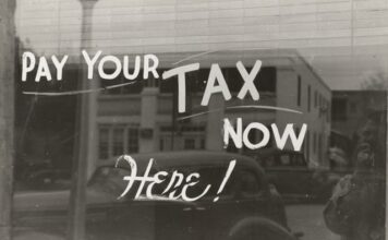 Window with pay your tax here written on it.