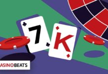 Two playing cards—7 of clubs and King of hearts—lie next to a red casino chip on a colorful gaming table.