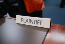 Courtroom sign reading “Plaintiff” on a desk