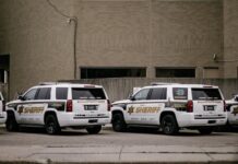 Sheriff vehicles parked outside a county building