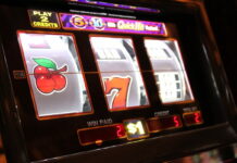 Close-up of a traditional slot machine showing spinning reels with symbols.