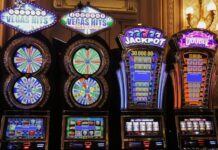 Slot machines with jackpot signage and flashing lights inside a casino